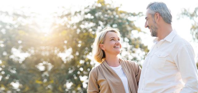 Senior Caucasian couple hugging in park